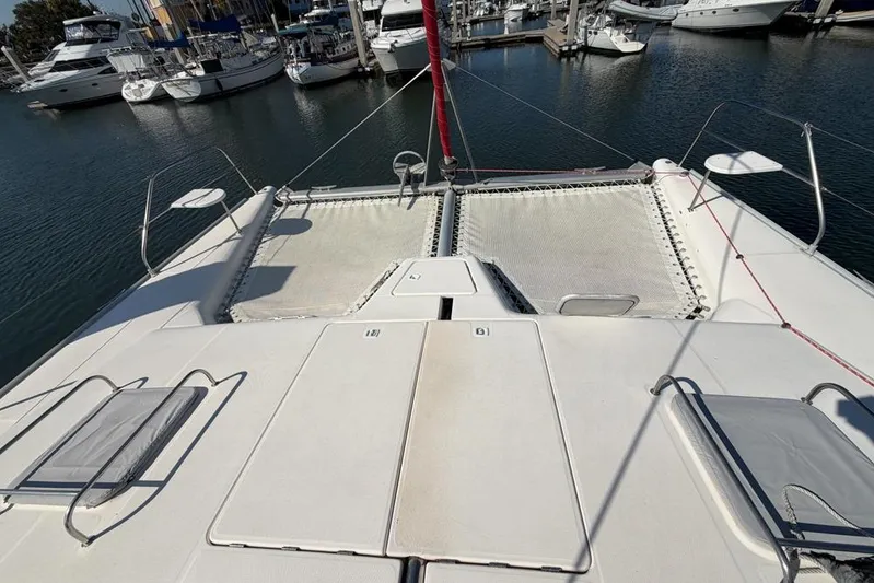 Next Of Kin Yacht Photos Pics Catamaran deck of 2000 Leopard 38, docked in marina with surrounding boats.