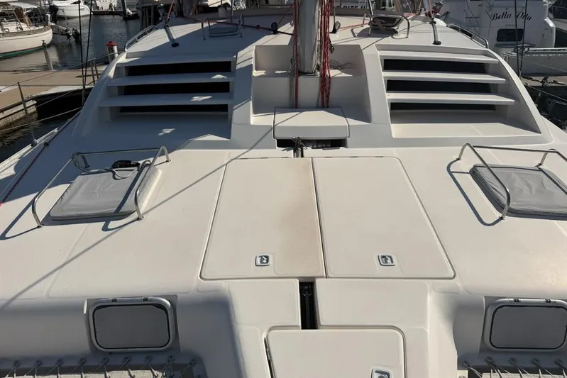 Next Of Kin Yacht Photos Pics Deck of a 2000 Leopard 38 catamaran docked at a marina.