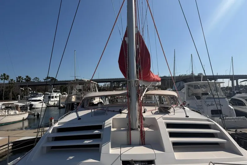 Next Of Kin Yacht Photos Pics Leopard 38 catamaran from 2000 docked in a sunny marina.