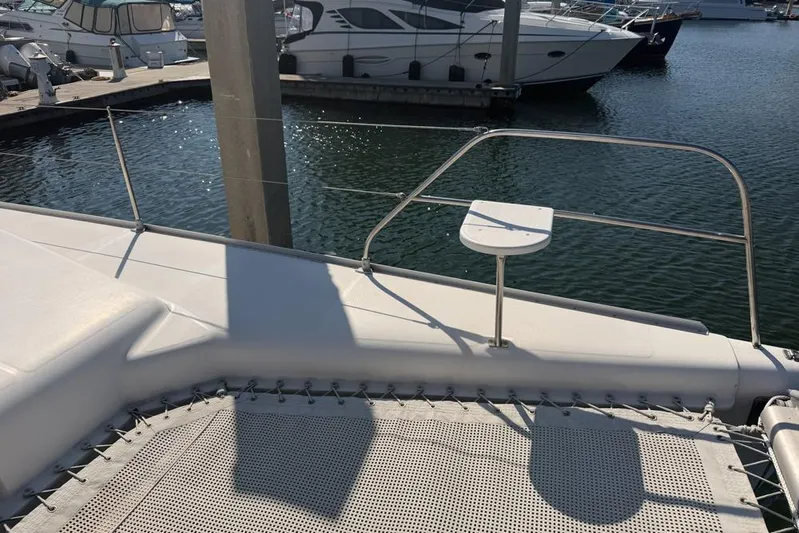 Next Of Kin Yacht Photos Pics Leopard 38 catamaran deck, 2000 model, docked at marina with other boats.