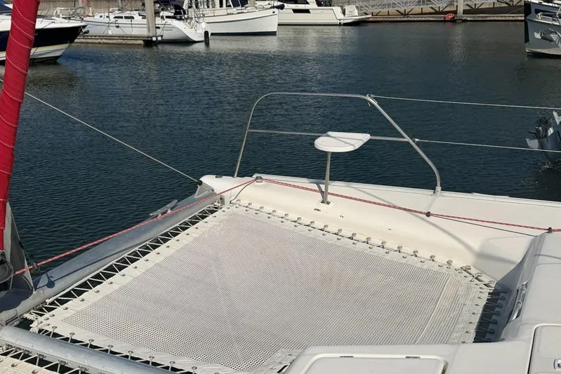Next Of Kin Yacht Photos Pics Leopard 38 catamaran deck with netting, docked in a marina, 2000 model.