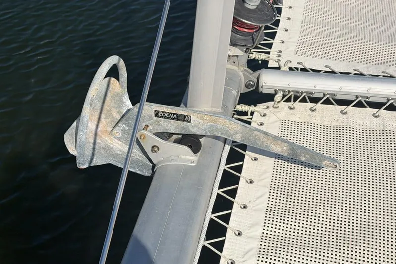 Next Of Kin Yacht Photos Pics Anchor on a 2000 Leopard 38 catamaran, secured on deck near netting.