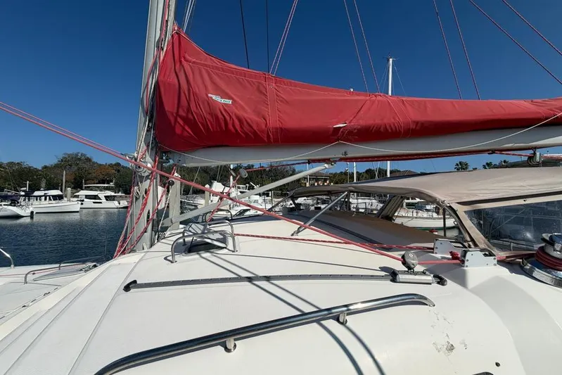 Next Of Kin Yacht Photos Pics Sailing yacht Leopard 38, 2000 model, with red sail cover, docked in marina.