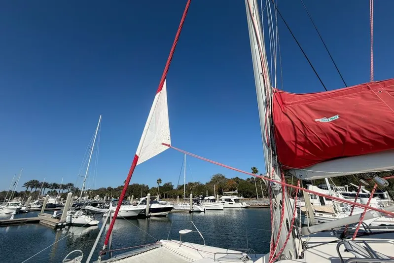 Next Of Kin Yacht Photos Pics Sailboat Leopard 38, 2000 model, docked in marina under clear blue sky.