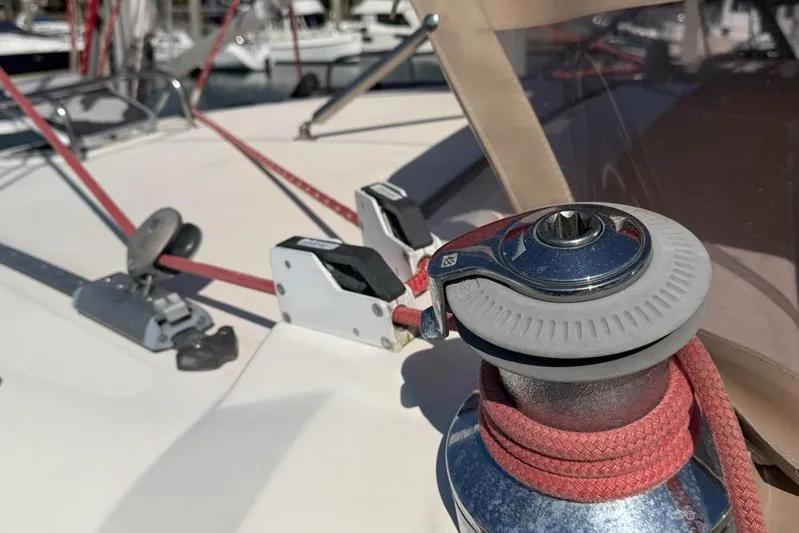 Next Of Kin Yacht Photos Pics Close-up of a Leopard 38 sailboat winch and ropes, showcasing deck details.