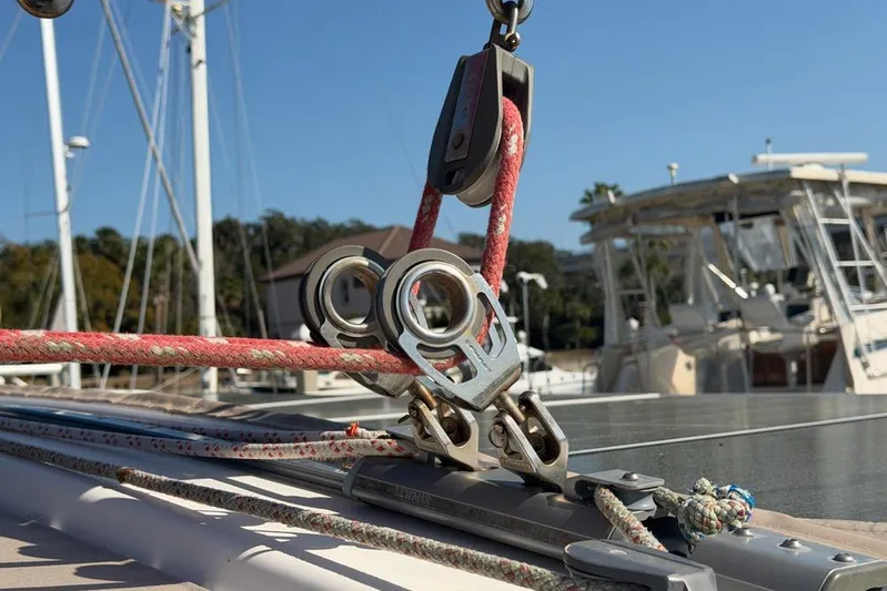 Next Of Kin Yacht Photos Pics Close-up of rigging on a 2000 Leopard 38 catamaran, showcasing ropes and pulleys.