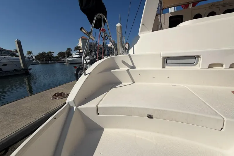 Next Of Kin Yacht Photos Pics Leopard 38 catamaran docked at marina, showcasing spacious deck area, 2000 model.