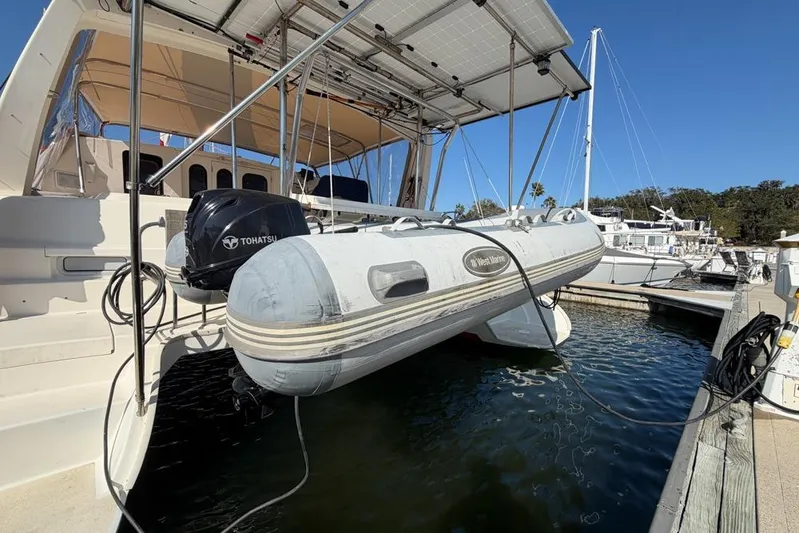 Next Of Kin Yacht Photos Pics Leopard 38 catamaran with dinghy and Tohatsu motor at marina, 2000 model.