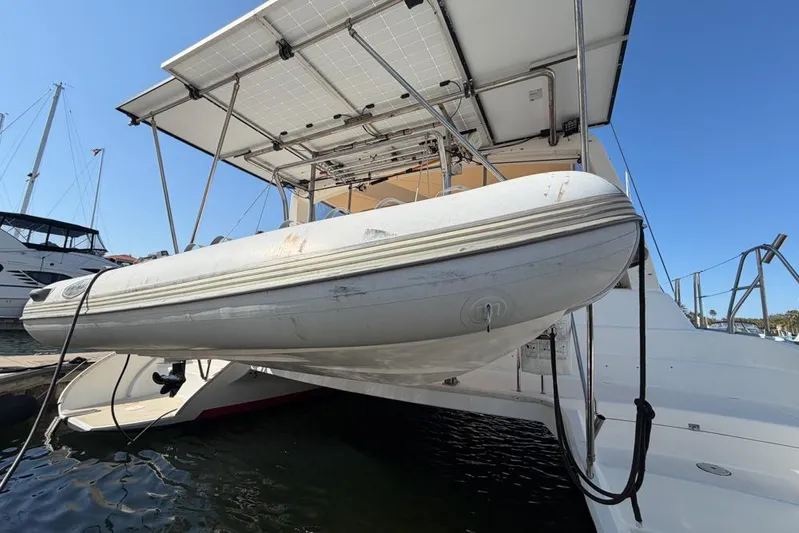 Next Of Kin Yacht Photos Pics Leopard 38 catamaran with solar panels and dinghy, docked in a marina, 2000 model.