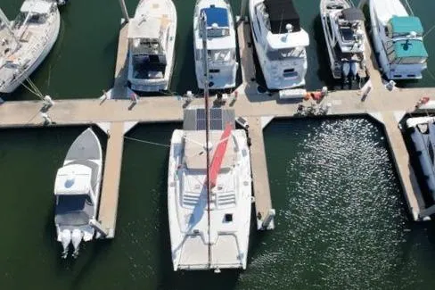 Next Of Kin Yacht Photos Pics Aerial view of boats docked at a marina, featuring a 2000 Leopard 38 catamaran.