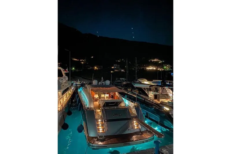 Eacos Yacht Photos Pics Luxurious Tecnomar Velvet 90 yacht illuminated at night in a serene marina, 2003 model.