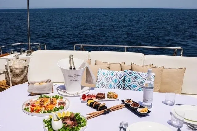 Eacos Yacht Photos Pics Luxurious dining setup on Tecnomar Velvet 90 yacht, 2003, with ocean view.