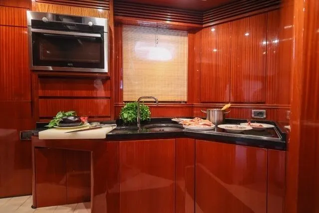 Eacos Yacht Photos Pics Luxurious kitchen interior on 2003 Tecnomar Velvet 90 yacht with modern appliances.