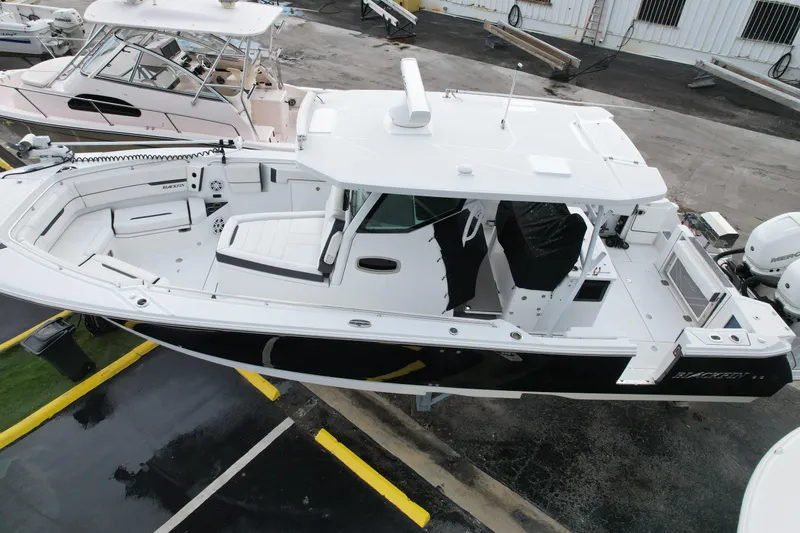  Yacht Photos Pics 2021 Blackfin 332 CC boat, aerial view, docked with sleek design and spacious deck.