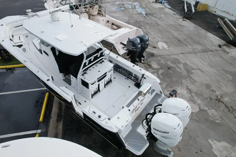  Yacht Photos Pics 2021 Blackfin 332 CC boat with dual Mercury engines, docked in a marina.