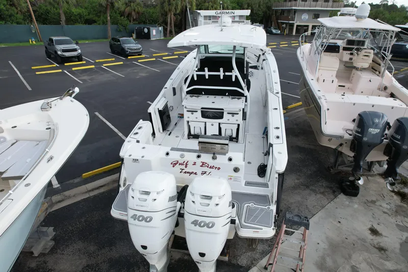  Yacht Photos Pics 2021 Blackfin 332 CC boat with twin Mercury 400 engines in a parking lot.