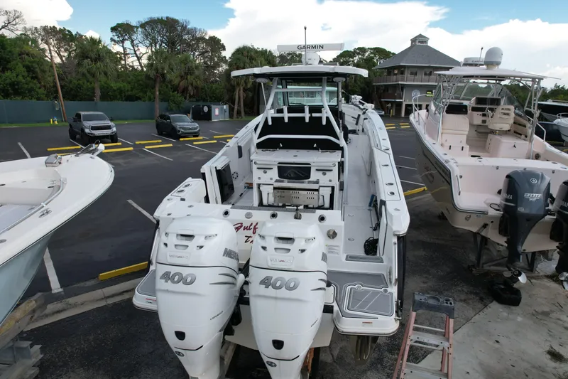  Yacht Photos Pics 2021 Blackfin 332 CC boat with twin 400 Mercury engines in a marina setting.
