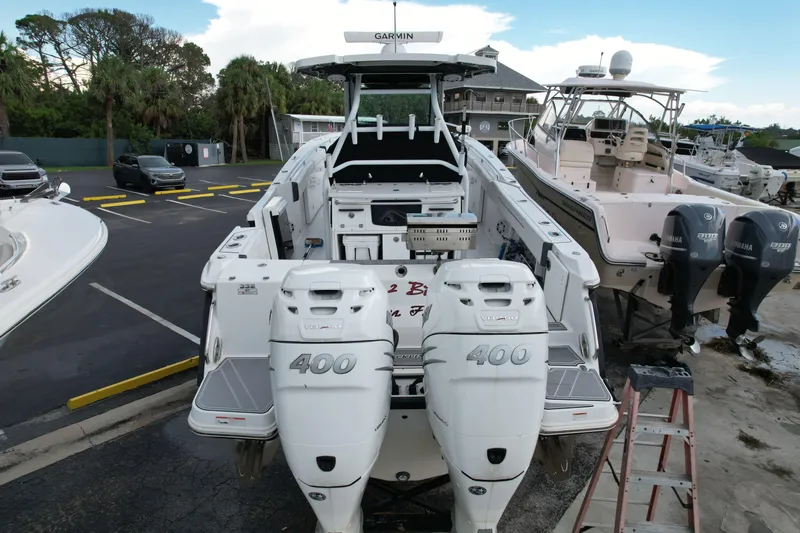  Yacht Photos Pics 2021 Blackfin 332 CC boat with twin 400 horsepower engines in a marina setting.