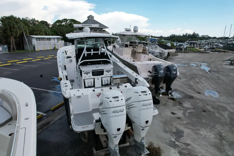  Yacht Photos Pics 2021 Blackfin 332 CC boat with powerful outboard engines in a marina setting.
