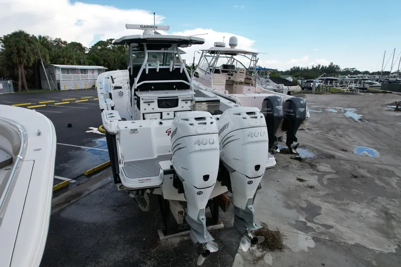  Yacht Photos Pics 2021 Blackfin 332 CC boat with dual Mercury 400 engines at a marina.