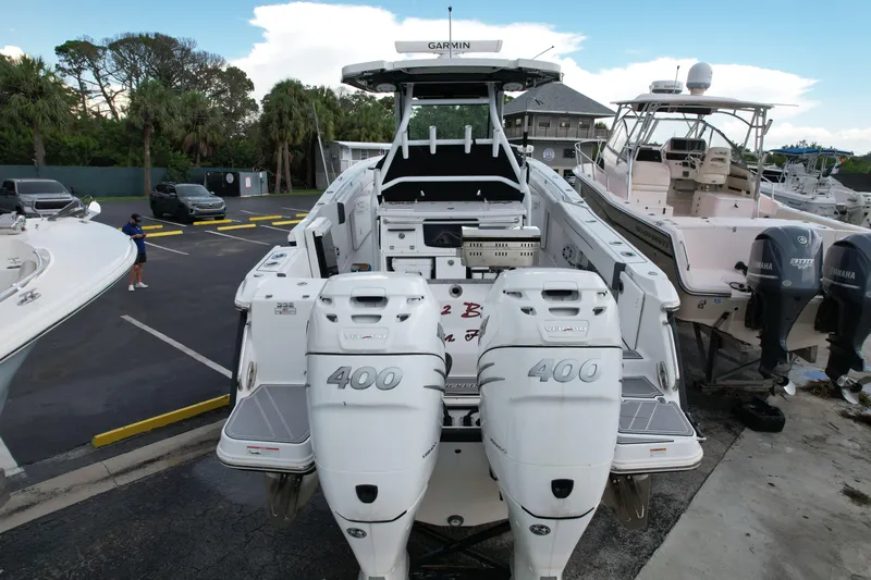  Yacht Photos Pics 2021 Blackfin 332 CC boat with twin 400 horsepower engines in a marina setting.