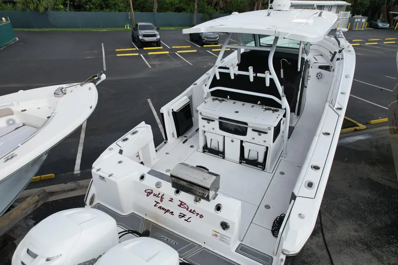  Yacht Photos Pics 2021 Blackfin 332 CC boat with dual engines, docked in a parking area.