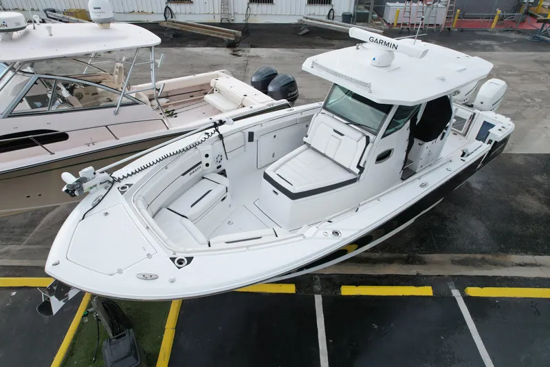  Yacht Photos Pics 2021 Blackfin 332 CC boat with advanced navigation equipment, docked in a marina.