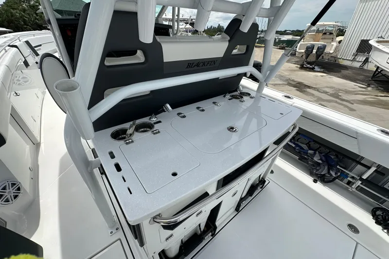  Yacht Photos Pics 2021 Blackfin 332 CC boat interior with fishing rod holders and storage compartments.