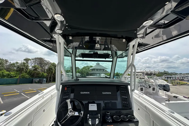  Yacht Photos Pics 2021 Blackfin 332 CC boat cockpit with Garmin navigation system, docked at marina.