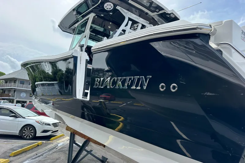  Yacht Photos Pics 2021 Blackfin 332 CC boat on display in a parking lot.