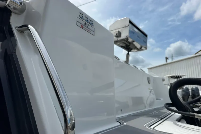  Yacht Photos Pics 2021 Blackfin 332 CC boat detail with radar, docked under cloudy sky.