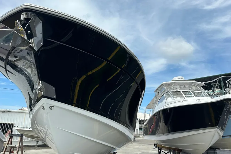  Yacht Photos Pics 2021 Blackfin 332 CC boats docked under a clear blue sky.