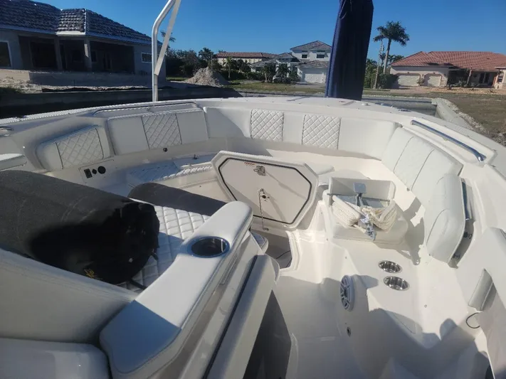  Yacht Photos Pics 2021 Pursuit S 378 Sport boat interior with white seating and storage compartments.