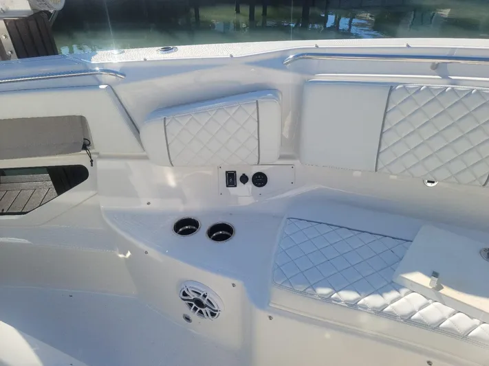  Yacht Photos Pics 2021 Pursuit S 378 Sport boat interior with quilted seating and cup holders.