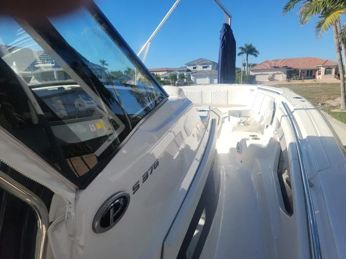  Yacht Photos Pics 2021 Pursuit S 378 Sport boat docked under clear blue sky.