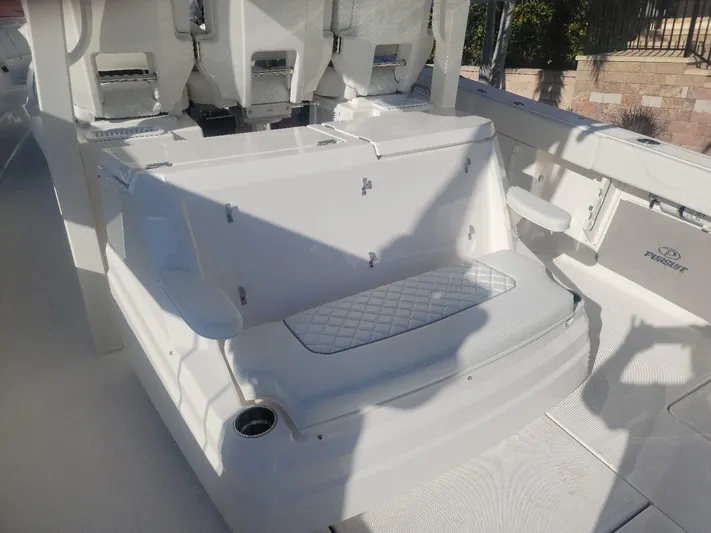  Yacht Photos Pics 2021 Pursuit S 378 Sport boat interior with seating and storage.