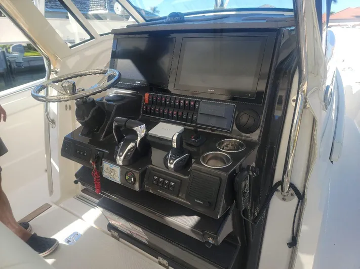  Yacht Photos Pics 2021 Pursuit S 378 Sport boat dashboard with advanced controls and navigation screens.