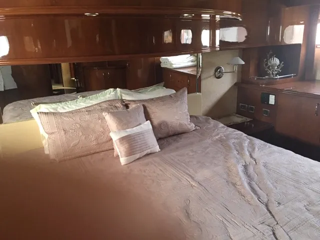 Silver Lining Yacht Photos Pics Luxurious bedroom interior of a 2005 Marquis Fly Bridge yacht with elegant bedding.