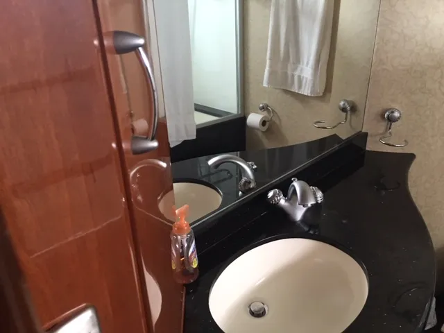 Silver Lining Yacht Photos Pics Bathroom sink area in a 2005 Marquis Fly Bridge yacht with black countertop.