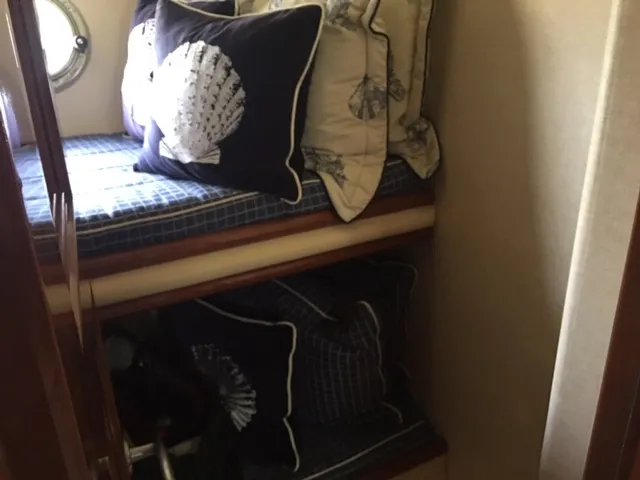 Silver Lining Yacht Photos Pics 2005 Marquis Fly Bridge yacht interior with bunk beds and nautical-themed pillows.