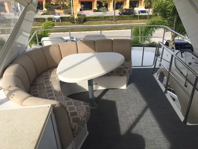 Silver Lining Yacht Photos Pics 2005 Marquis Fly Bridge with cushioned seating and table.