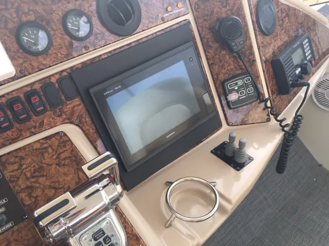 Silver Lining Yacht Photos Pics 2005 Marquis Fly Bridge control panel with navigation screen and communication devices.