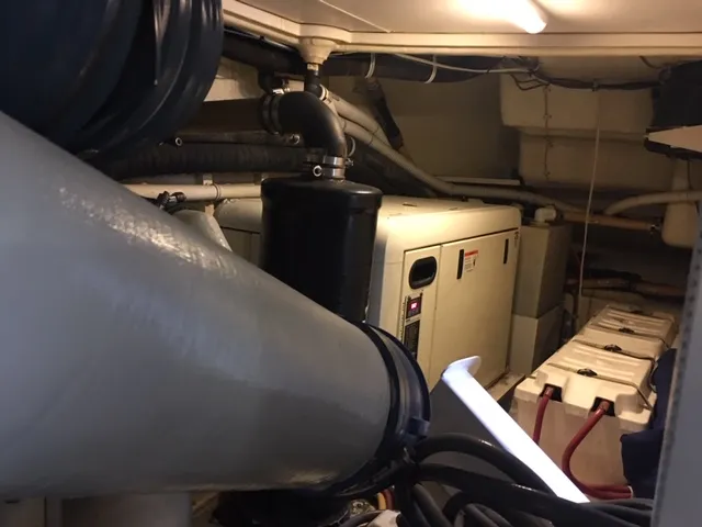 Silver Lining Yacht Photos Pics Engine room of a 2005 Marquis Fly Bridge yacht with visible machinery and equipment.