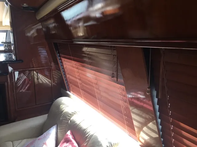 Silver Lining Yacht Photos Pics Interior of 2005 Marquis Fly Bridge yacht with wooden blinds and leather seating.