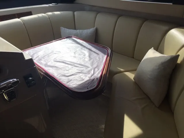 Silver Lining Yacht Photos Pics 2005 Marquis Fly Bridge yacht interior with cushioned seating and table.