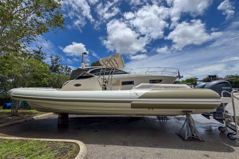  Yacht Photos Pics 2023 Tender Impertus 36 boat on display under a partly cloudy sky.