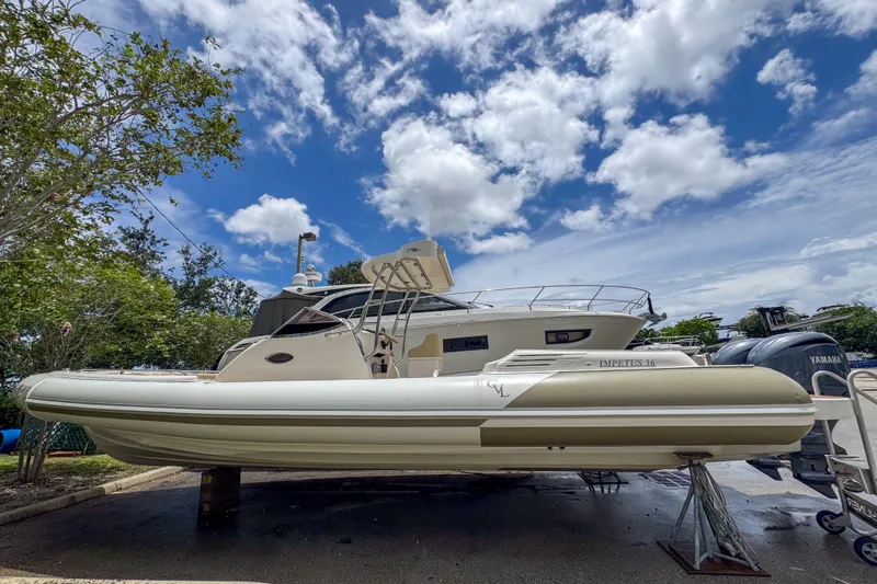  Yacht Photos Pics 2023 Tender Impertus 36 boat on display under a partly cloudy sky.