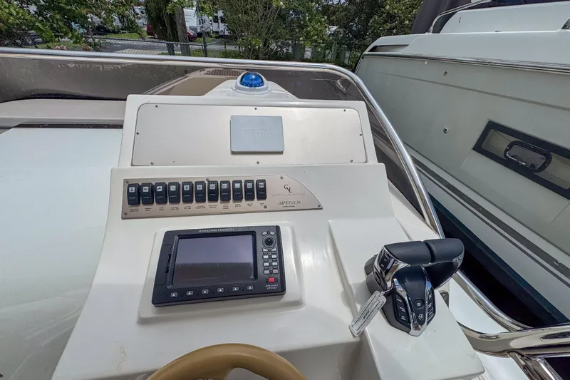  Yacht Photos Pics Control panel of 2023 Tender Impertus 36 boat with navigation system and throttle controls.