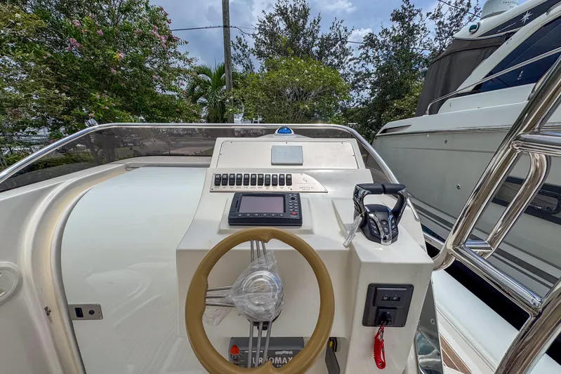  Yacht Photos Pics 2023 Tender Impertus 36 boat dashboard with steering wheel and control panel.