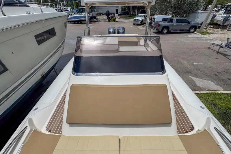  Yacht Photos Pics 2023 Tender Impertus 36 boat with spacious deck and sleek design in a marina setting.